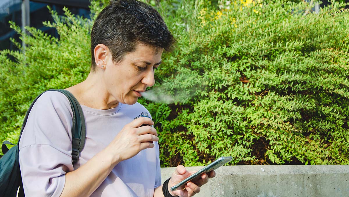 a woman using a device to smoke