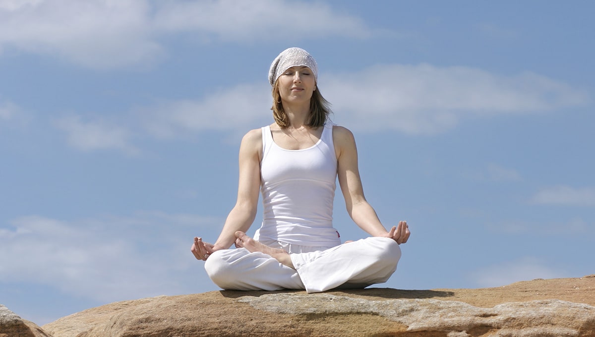 a woman sitting on a rock